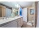 Bathroom with dual sinks, granite counters, and a well-lit mirror at 1350 Gulf Blvd # 502, Clearwater Beach, FL 33767