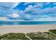 Expansive white sand beach with beautiful ocean views and a cloudscape at 1350 Gulf Blvd # 502, Clearwater Beach, FL 33767