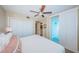 Bright bedroom with a ceiling fan and access to a private balcony with serene views at 1350 Gulf Blvd # 502, Clearwater Beach, FL 33767