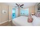Bright bedroom with a ceiling fan, balcony access, and scenic views of the outside at 1350 Gulf Blvd # 502, Clearwater Beach, FL 33767