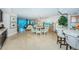Open-concept dining area with a chandelier, views of the living area and ocean beyond at 1350 Gulf Blvd # 502, Clearwater Beach, FL 33767