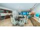 Open-concept dining area features a chandelier, adjacent bar, and ocean views at 1350 Gulf Blvd # 502, Clearwater Beach, FL 33767
