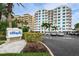 Beautiful Utopia condo building with lush landscaping and a well-maintained parking area at 1350 Gulf Blvd # 502, Clearwater Beach, FL 33767