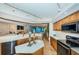 Open-concept kitchen with wooden cabinets and stainless steel appliances at 1350 Gulf Blvd # 502, Clearwater Beach, FL 33767