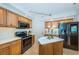 Well-lit kitchen with stainless steel appliances and wooden cabinets at 1350 Gulf Blvd # 502, Clearwater Beach, FL 33767