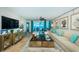 Bright living room featuring coastal decor, comfortable seating, and access to a private balcony with ocean views at 1350 Gulf Blvd # 502, Clearwater Beach, FL 33767