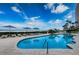 Beautiful pool area with lounge chairs, umbrellas, palm trees, and beach access under a bright sky at 1350 Gulf Blvd # 502, Clearwater Beach, FL 33767