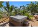 Backyard wooden deck featuring a covered hot tub surrounded by lush greenery at 1508 Eden Isle Ne Blvd, St Petersburg, FL 33704
