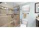 Modern bathroom with a walk-in shower enclosed by glass and light brown tiled surround at 1508 Eden Isle Ne Blvd, St Petersburg, FL 33704
