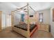 Bright bedroom with a decorative four poster bed, ceiling fan, and neutral colors throughout at 1508 Eden Isle Ne Blvd, St Petersburg, FL 33704