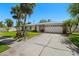 Charming home featuring a well-maintained lawn, two-car garage, and inviting curb appeal at 1508 Eden Isle Ne Blvd, St Petersburg, FL 33704