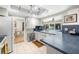 Updated kitchen with white cabinets, stainless steel appliances, and an opening to the backyard at 1508 Eden Isle Ne Blvd, St Petersburg, FL 33704
