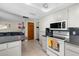 Well lit Kitchen with white cabinets and appliances and an island counter at 1508 Eden Isle Ne Blvd, St Petersburg, FL 33704