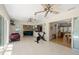 Spacious living room with tile flooring, fans, and connecting sliding doors to the backyard at 1508 Eden Isle Ne Blvd, St Petersburg, FL 33704