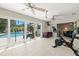 Sunny patio with large sliding glass doors opening to pool area and view of the back yard at 1508 Eden Isle Ne Blvd, St Petersburg, FL 33704