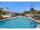 Backyard swimming pool with a pool ladder and outdoor seating area at 1508 Eden Isle Ne Blvd, St Petersburg, FL 33704