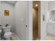 The bathroom features a toilet, door, and a shower stall in the background, for daily grooming at 1537 Ember Ln, Tarpon Springs, FL 34689