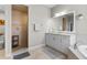 Bright bathroom featuring a walk-in shower, soaking tub, vanity, and mirror, offering complete convenience at 1537 Ember Ln, Tarpon Springs, FL 34689