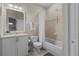 Well-maintained bathroom featuring a shower-tub combo, white vanity, and tiled floor at 1537 Ember Ln, Tarpon Springs, FL 34689