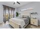 Stylish bedroom with a large bed, decorative shelving, and a balcony view at 1537 Ember Ln, Tarpon Springs, FL 34689