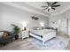 Spacious bedroom with a ceiling fan, white furnishings, and a large rug over wood-look floors at 1537 Ember Ln, Tarpon Springs, FL 34689