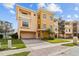 Charming multi-story townhome with a well-maintained lawn, two-car garage, and a private balcony at 1537 Ember Ln, Tarpon Springs, FL 34689
