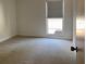 Clean bedroom with carpeting, a window, and light-colored walls at 1655 S Highland Ave # I286, Clearwater, FL 33756