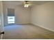 Bedroom with neutral carpeting, a window, and a ceiling fan at 1655 S Highland Ave # I286, Clearwater, FL 33756