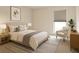 Cozy bedroom featuring neutral tones, soft rug, a comfortable chair by the window, and stylish bedside lamps at 1655 S Highland Ave # I286, Clearwater, FL 33756
