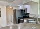 Functional kitchen area featuring a stainless steel refrigerator, range, and a convenient sink at 1655 S Highland Ave # I286, Clearwater, FL 33756