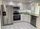 Well-lit kitchen with stainless steel appliances, white cabinets, and a dishwasher at 1655 S Highland Ave # I286, Clearwater, FL 33756