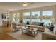 Bright living room with large windows offering a scenic water view, ceiling fan, and adjacent dining area at 1655 S Highland Ave # I286, Clearwater, FL 33756