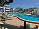 Inviting community pool area featuring lounge chairs, tables, and well-maintained landscaping at 1655 S Highland Ave # I286, Clearwater, FL 33756