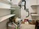 Image of the utility room featuring a water heater, HVAC system, and shelves for storage at 1655 S Highland Ave # I286, Clearwater, FL 33756