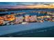 An aerial view of beachfront condos, the shore, and the surrounding city at twilight at 17920 Gulf Blvd # 2004, Redington Shores, FL 33708
