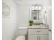 Bathroom with white cabinetry, granite vanity, and decorative seashell accents at 17920 Gulf Blvd # 2004, Redington Shores, FL 33708
