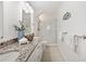 Bright bathroom features double sinks, granite countertops, and a glass-enclosed shower at 17920 Gulf Blvd # 2004, Redington Shores, FL 33708