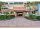 Inviting entrance area with lush landscaping around brick-paved walkway at 17920 Gulf Blvd # 2004, Redington Shores, FL 33708
