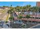 Exterior view of the landscaped property with palm trees and ocean views in the background at 17920 Gulf Blvd # 2004, Redington Shores, FL 33708