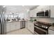 Modern kitchen features white cabinetry, granite countertops, stainless steel appliances, and ocean views at 17920 Gulf Blvd # 2004, Redington Shores, FL 33708