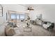 Inviting living room with ocean views, comfortable seating, ceiling fan, and access to the balcony at 17920 Gulf Blvd # 2004, Redington Shores, FL 33708