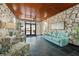 Inviting lobby area featuring stone walls, tile floors, comfortable seating, and well-maintained decor at 17920 Gulf Blvd # 2004, Redington Shores, FL 33708