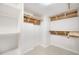 Spacious walk-in closet, equipped with custom wood shelving, to maximize storage solutions at 17920 Gulf Blvd # 2004, Redington Shores, FL 33708