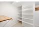 Walk-in pantry features adjustable shelving with wood accents, providing ample storage space at 17920 Gulf Blvd # 2004, Redington Shores, FL 33708