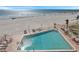 Elevated pool deck featuring a large pool surrounded by lounge chairs with ocean view at 17920 Gulf Blvd # 2004, Redington Shores, FL 33708