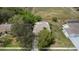 Aerial view of a home with mature trees, green grass, and neutral-colored roof at 18241 Autumn Lake Blvd, Hudson, FL 34667
