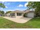 Spacious backyard with a concrete patio and enclosed sunroom, perfect for outdoor entertaining at 18241 Autumn Lake Blvd, Hudson, FL 34667