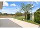 Well-maintained backyard featuring lush green grass, mature trees, and a decorative trellis at 18241 Autumn Lake Blvd, Hudson, FL 34667