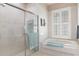 Bright bathroom featuring a tub and a separate glass enclosed shower and shuttered window at 18241 Autumn Lake Blvd, Hudson, FL 34667