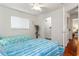 Charming bedroom with two twin beds, a ceiling fan, and a walk-in closet at 18241 Autumn Lake Blvd, Hudson, FL 34667